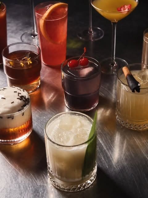 Plusieurs cocktails colorés servis au comptoir de Derrière l’Abbaye